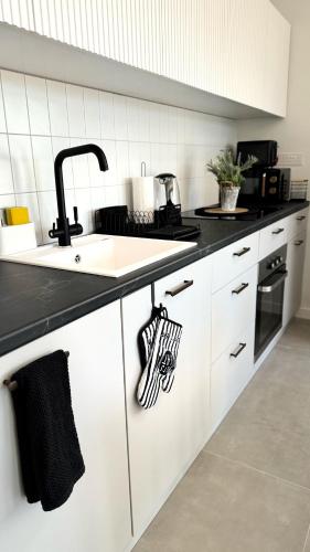 a kitchen with a sink and a counter top at Peyia Paradise Apt in Peyia