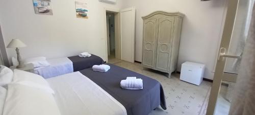 a hotel room with two beds and a closet at Mediterraneo in Scilla