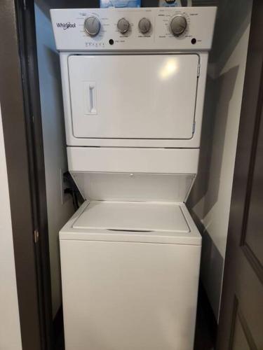 a white stove sitting on top of a refrigerator at Downtown Augusta Beauty 2 Bed Apt in Augusta