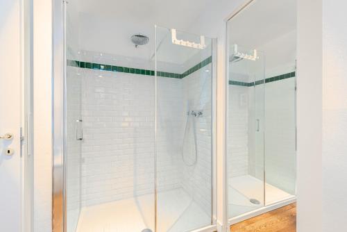 a shower with glass doors in a bathroom at Casa Rita, Charming House with pool, Asti in Asti