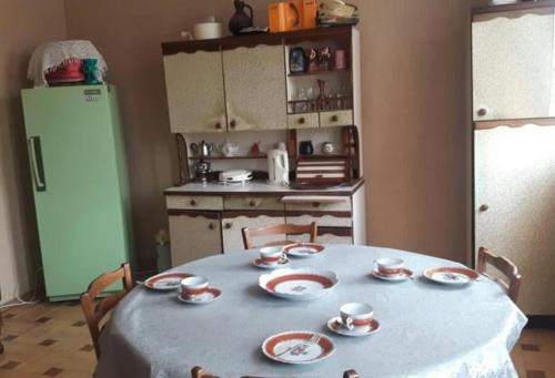 a kitchen with a table with cups and plates on it at Guli in Gori
