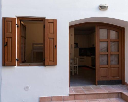 an entrance to a house with a door and window at Appartamento La Corte in Levico Terme