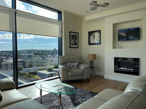a living room with a couch and a glass table at The Western Citypoint Apartments in Galway