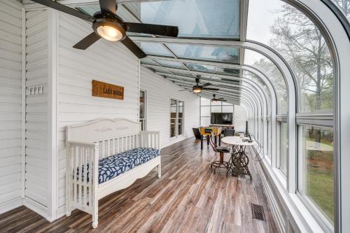 a bedroom with a crib and a table in a room at Lakefront Milledgeville Home with Private Dock! in Resseaus Crossroads
