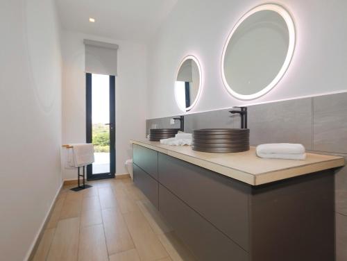a bathroom with a sink and a mirror at Hermosa Bay Oceanview Villa in Boca Chica
