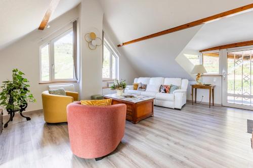 a living room with a couch and two chairs at Les Glycines du Sommerberg in Niedermorschwihr