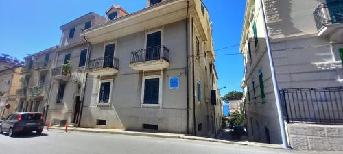 a car parked in front of a building on a street at Mediterraneo in Scilla