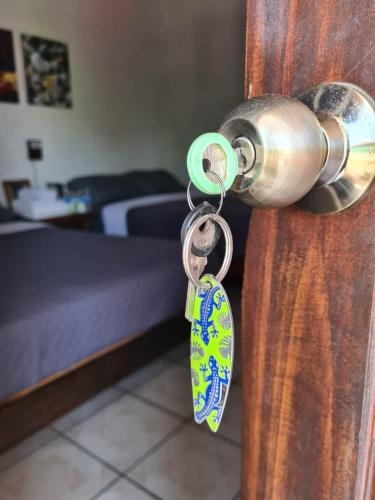 a door knob with a pair of tags on it at Hotel del Callejón in Zihuatanejo