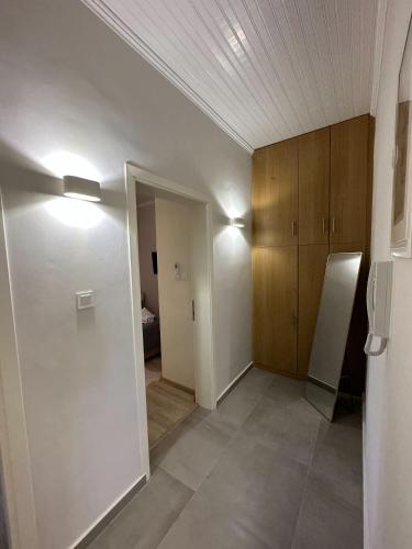 an empty room with a hallway with a refrigerator at Diamond Suite in Diakopto