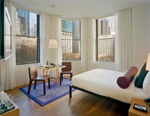 Schlafzimmer mit einem Bett, einem Tisch und Stühlen in der Unterkunft Bryant Park Hotel in New York