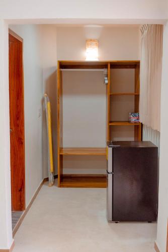 a kitchen with a refrigerator in a room at Casa Victoria Puerto Escondido Beach in Brisas de Zicatela