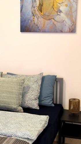 a bedroom with a bed and a painting on the wall at PMP Adamia Apartments in Peyia
