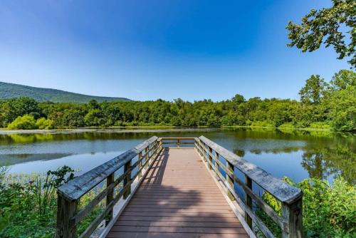 a wooden boardwalk over a lake in a park at Cabin w hot tub & fire pit Shenandoah River in Luray