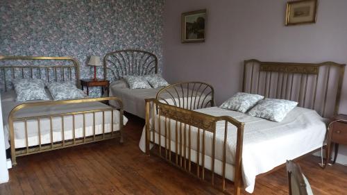 מיטה או מיטות בחדר ב-Gite du Manoir des Anoteux