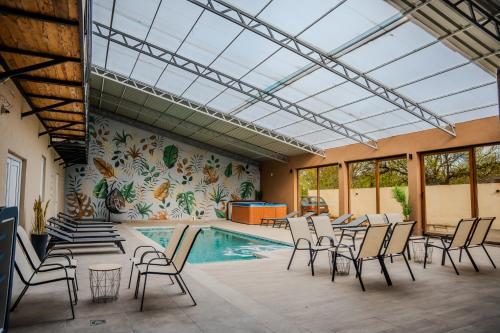 a pool with chairs and a table and a swimming pool at Plaza La - Night and Spa in Sremska Mitrovica