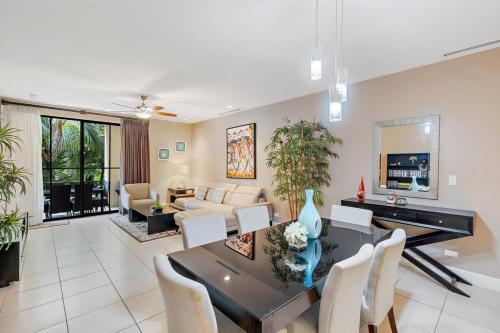 a dining room and living room with a table and chairs at 3BD Beauty in Coco - Have Coffee or Meals Overlooking Pool in Coco