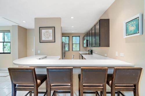 a kitchen with a large island with chairs around it at 3BD Beauty in Coco - Have Coffee or Meals Overlooking Pool in Coco