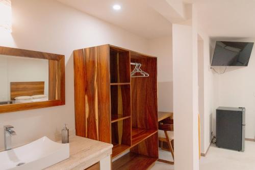 a bathroom with a wooden cabinet and a sink at Casa Victoria Puerto Escondido Beach in Brisas de Zicatela