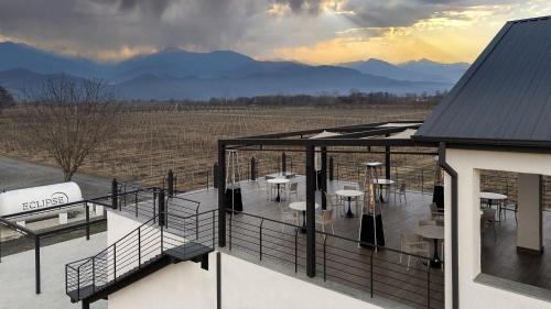 a balcony of a house with tables and chairs at Eclipse Winery Boutique Hotel in Kvareli