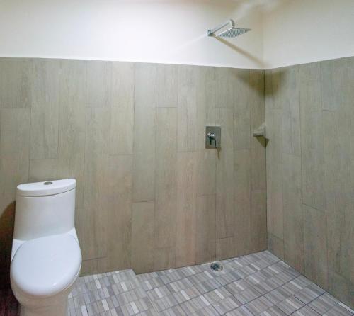 a bathroom with a toilet and a shower at Casa Victoria Puerto Escondido Beach in Brisas de Zicatela