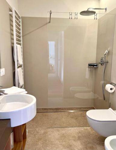 a bathroom with a sink and a toilet and a shower at Hotel Gartenresidence Zea Curtis in Merano
