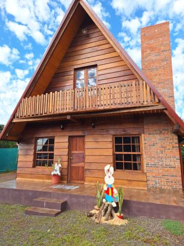 a wooden house with a deck on top of it at Fi-Scheer Bungalows in Bella Vista