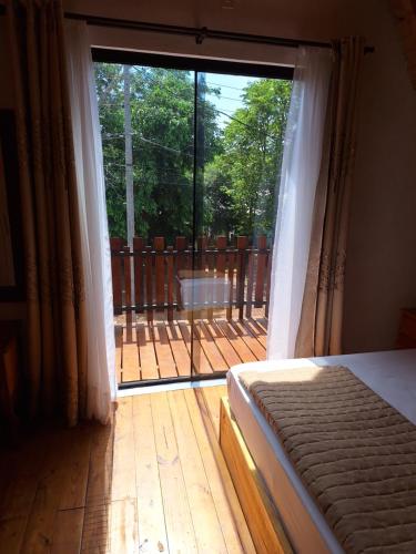 a bedroom with a large sliding glass door to a deck at Fi-Scheer Bungalows in Bella Vista
