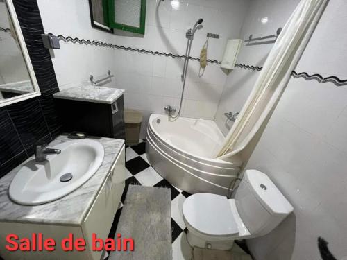 a white bathroom with a sink and a toilet at Villa Bel air in Aïn Draham