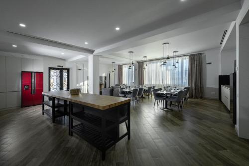 a dining room with tables and chairs in a room at Eclipse Winery Boutique Hotel in Kvareli