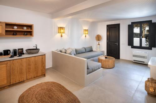 a living room with a couch and a table at Venus Sunrise Suites & Villas in Vourvoulos