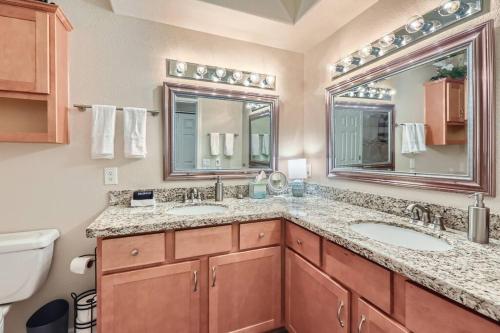 a bathroom with two sinks and two mirrors at 2bd/1ba North Scottsdale Condo in Scottsdale