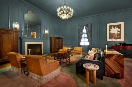 a living room filled with furniture and a chandelier at Marcus Whitman Hotel and Conference Center in Walla Walla