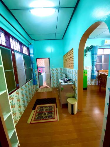 a room with blue walls and a table and a rug at สีชังสมายด์ in Ko Si Chang