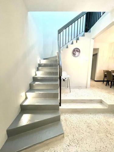 a stairway in a building with a metal railing at 4-10Pax The Subang Premium House - The Heart Of Subang in Subang Jaya