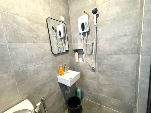 a bathroom with a shower and a white sink at 4-10Pax The Subang Premium House - The Heart Of Subang in Subang Jaya