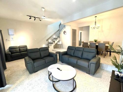 a living room with two couches and a table at 4-10Pax The Subang Premium House - The Heart Of Subang in Subang Jaya
