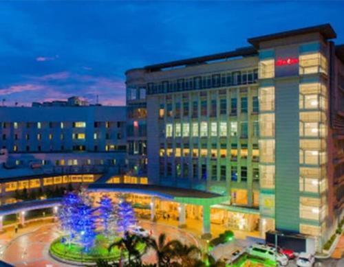 a large building with a fountain in front of it at 4-10Pax The Subang Premium House - The Heart Of Subang in Subang Jaya