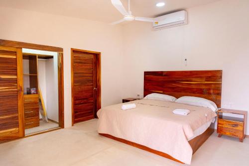 a bedroom with a bed and a ceiling fan at Casa Victoria Puerto Escondido Beach in Brisas de Zicatela