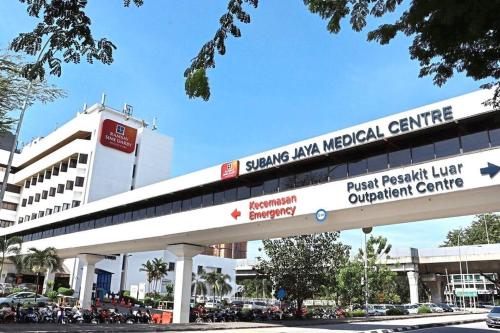 a building with a sign for a medical center at 4-10Pax The Subang Premium House - The Heart Of Subang in Subang Jaya