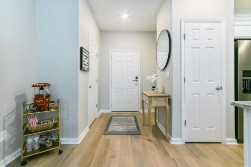 a hallway with two white doors and a mirror at Brand New Luxury -King Bed- 15 min to attractions in Saint Augustine