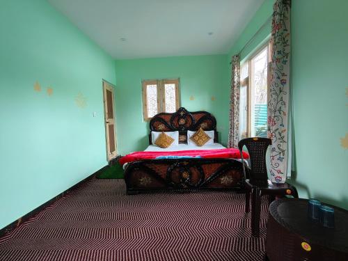 - une chambre avec un lit dans une pièce aux murs verts dans l'établissement Valley Guest House Pahalgam, à Kolur
