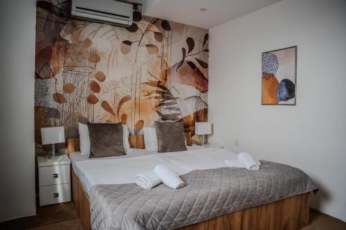 a bedroom with a bed with white towels on it at Plaza La - Night and Spa in Sremska Mitrovica