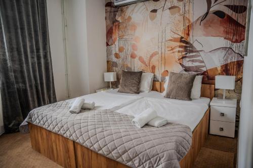 a bedroom with a bed with two pillows on it at Plaza La - Night and Spa in Sremska Mitrovica