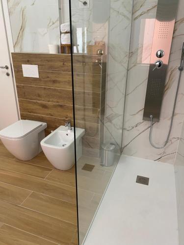 a bathroom with a shower with a toilet and a sink at Ale.Zelo Apartment in Zelo Buon Persico