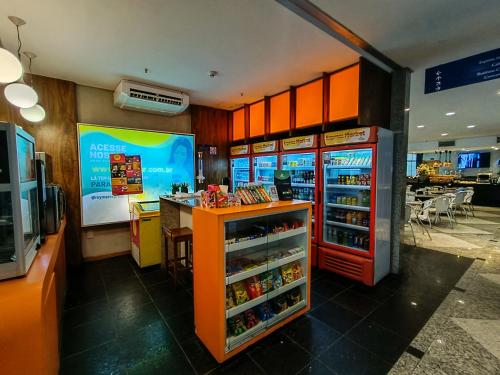 a fast food restaurant with a counter and a refrigerator at Reymar Hotel Maceió in Maceió