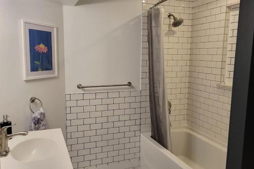 a bathroom with a tub and a sink and a shower at Beautiful newly designed Luxurious Apartment in Windsor