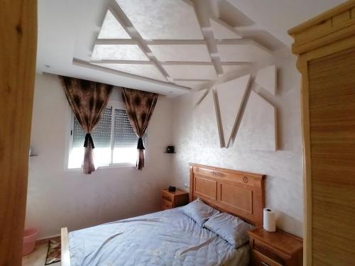 um quarto com uma cama e uma janela em Lagouira d'Agadir em Agadir