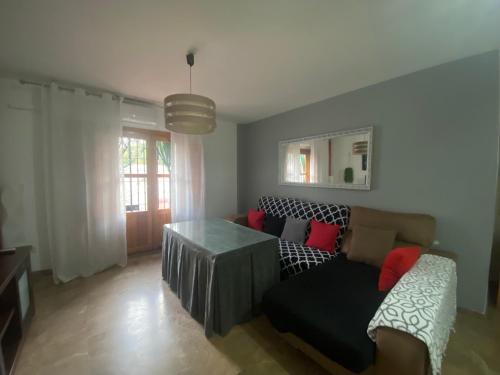 a living room with a couch and a table at La Casa Del Buda in Güéjar-Sierra