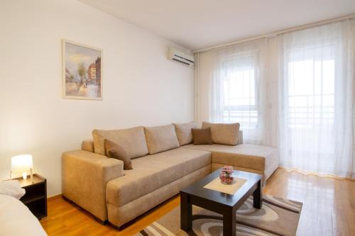 a living room with a couch and a table at Delta Residence Belville in Belgrade