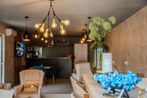 a vase with plants in it sitting on a table at Plaza La - Night and Spa in Sremska Mitrovica